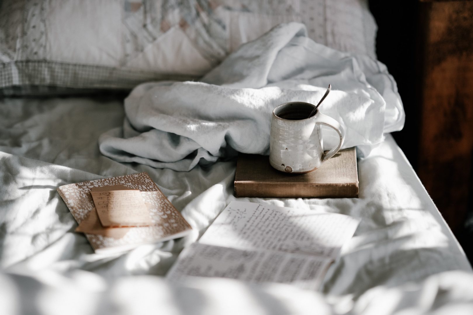 Seasonal creativity - Mug and notebooks on bed